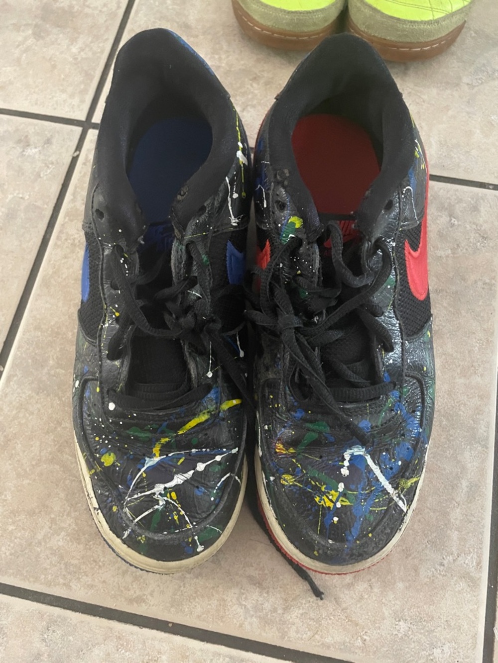Nike Kids Black Sneakers with Red Swoosh and Multicolor Paint Splatter